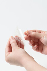 Round patches for acne and wrinkles on the hands on a white background. Acne and wrinkle patches...