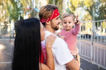 Dad, mom and daughter walk in the fresh air in the evening