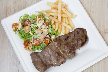 Homemade lunch with grilled meat and French fries