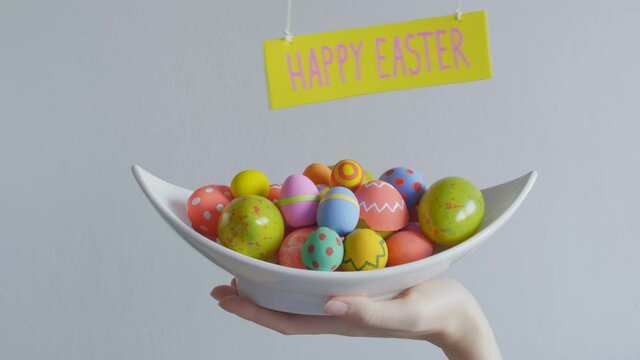 Girl holding basket with Easter painted eggs,holiday concept