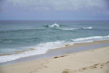 Sea with small waves at Praia da Reserva, on a partially cloudy day. Located in Rio de Janeiro