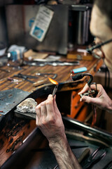 Hands of an artisan Making Handmade Jewelry