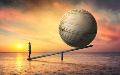 Balance concept of man and big wooden ball.