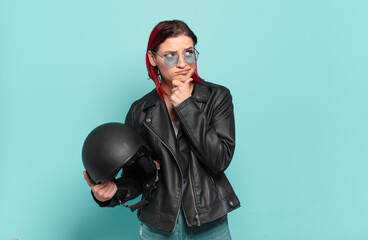 young attractive red hair woman thinking, feeling doubtful and confused, with different options,...