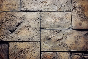 The texture of a fragment of a wall made of large stone slabs