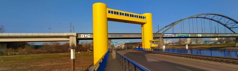 A yellow raisable bridge in the harbour