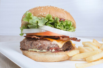 Traditional hamburger of beef, tomato, lettuce, onion and cheese