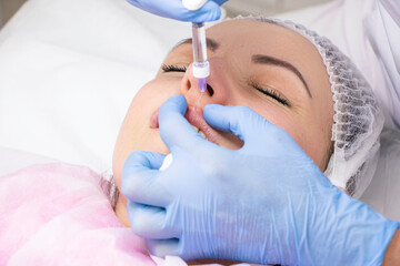 Naklejka premium Cosmetology, lip augmentation, beauty injections in a beauty salon, close up