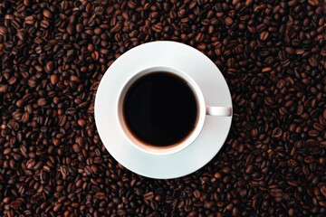 White plate, cup of coffee on a bunch of roasted coffee beans background