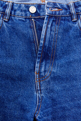 Close-up of middle of open denim indigo blue jeans, with two belt loops and crotch