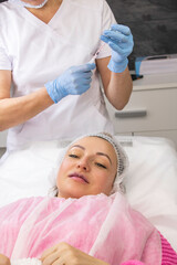 Cosmetology, lip augmentation, beauty injections in a beauty salon, close up