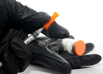 Covid-19 vaccination. Syringe, gloves, vaccine. Close-up