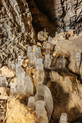 Fascinating ice formations and icicles in Chlum limestone quarry and caves,Czech Republic.Cave system in Cesky kras, Czech Karst.Freezing day outdoors.Wild natural winter scenery.Day trip from Prague.
