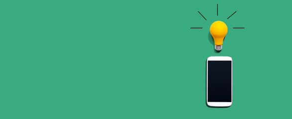 Smartphone with a yellow light bulb from above © Tierney