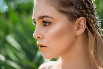 Portrait of beauty model with yellow creative makeup.