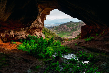 beautiful cave in the andes of peru with a look to the tinajani canyon with a beautiful blue sky...