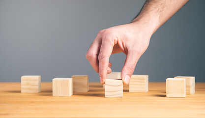 Hand holding wooden block cubes