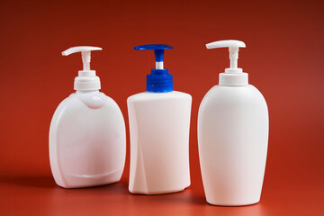 Set of three clean white plastic bottles with soap dispenser