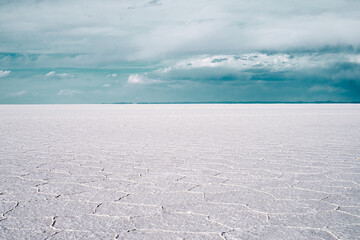 Fototapeta na wymiar Beautiful Bolivia's Salt Flats. Shot in Salar de Uyuni salt flat. Water reflection of clouds and empty space. 