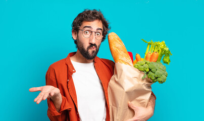 young bearded man feeling puzzled and confused, doubting, weighting or choosing different options...