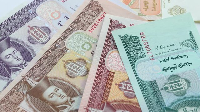 Mongolia currency. banknotes falling and rotating slowly on their own axis. economy concept