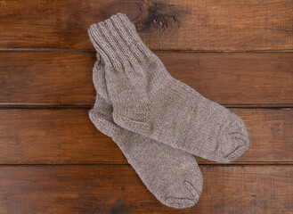 Top view on grey  socks on a wooden background. Close up.