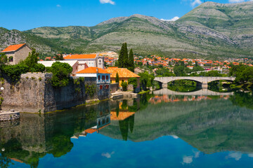 Fototapeta na wymiar Stone bridge and old town by Trebisnjica River, Trebinje, Bosnia and Herzegovina