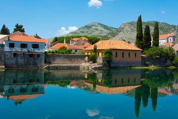 Old town by Trebisnjica River with reflection in the water, Trebinje, Bosnia and Herzegovina