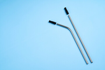 The modern trend towards caring for the environment. Two reusable metal beverage straws with silicone caps