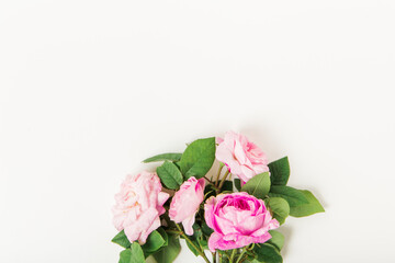 Floral composition with pink roses on white background. Flat lay, top view. Flower background. Spring and beauty concept