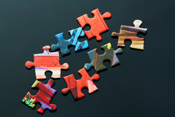 pieces of the puzzle are scattered on the table in different directions