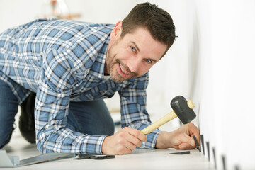 a handyman installing wooden floor