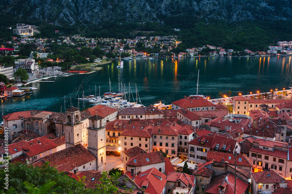 Poster Red roof houses and boats on the Adriatic coast in the Bay of Kotor at dusk, Montenegro