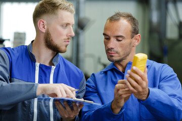 technicians measure contract resistance in control panel
