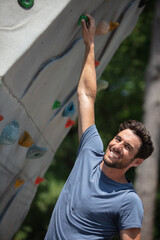 people bouldering on a climbing wall outdoor