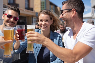 group of friends toasting beers outdoors