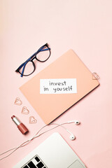 The inscription "Invest in yourself" on a pink background