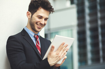 Young manager using a digital tablet outdoor