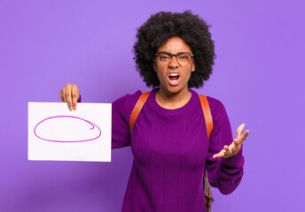 young student afro woman looking angry, annoyed and frustrated screaming wtf or what’s wrong with...
