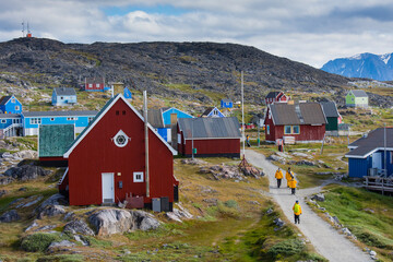 Greenland. Itilleq. Visitors exploring town.
