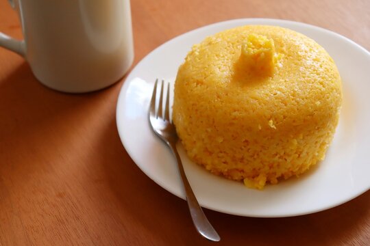 Brazilian Couscous (Cuscuz Brasileiro) and a cup of coffee on wooden background. Brazilian breakfast.