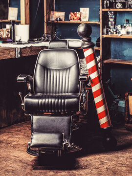 Logo of the barbershop, symbol. Stylish vintage barber chair. Hairstylist in barbershop interior. Barber shop chair. Barbershop armchair, salon, barber shop for men. Barber shop pole