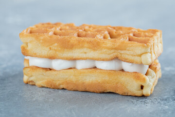 Delicious fresh waffle on a gray background