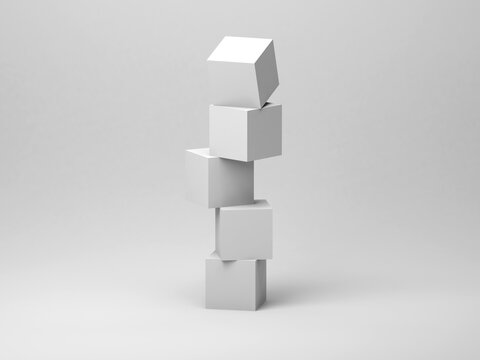 Abstract tower installation of five white cubes in an empty studio © evannovostro