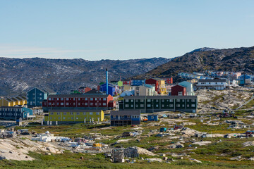 Fototapeta na wymiar Greenland. Ilulissat. Dog town and houses beyond.