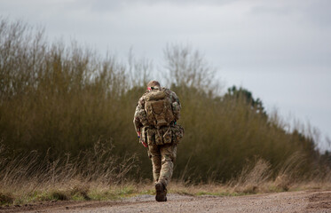 soldier completing an 8 mile tabbing exercise with fully loaded bergen