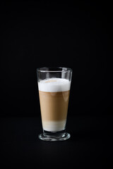 Coffee with milk on dark background. Copy space.	