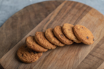 Stack of chocolate chip cookies on wooden board