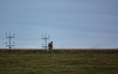 Fototapeta na wymiar British Army soldier completing an 8 mile tabbing exercise with fully loaded 25kg bergen