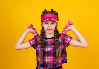 Be strong. teen girl training. dedicated to fitness. sport tools and equipment. healthy and active lifestyle. full of energy. happy childhood. kid in cap hold barbells. child with dumbbells